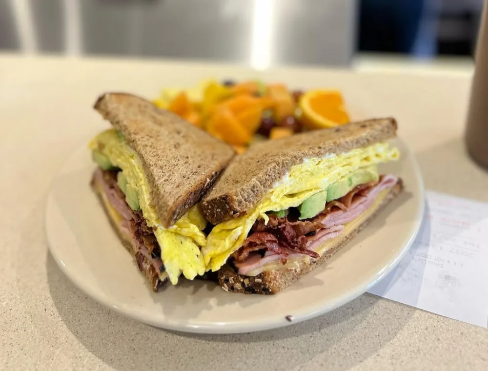 Breakfast club sandwich with egg and avocado on a plate