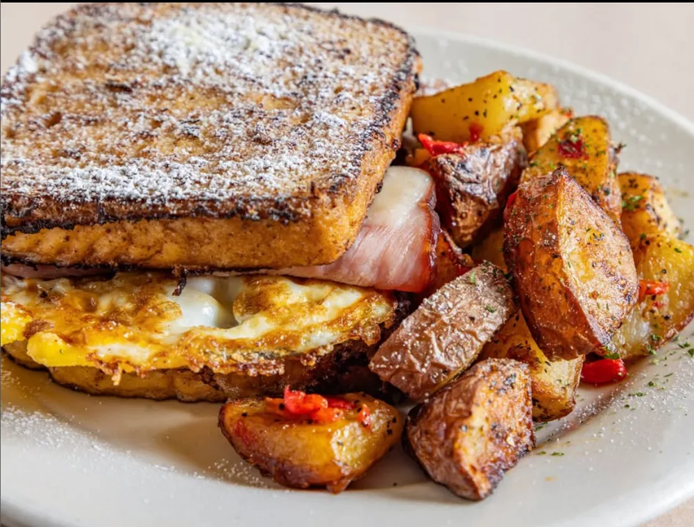 Breakfast sandwich served with roasted potatoes